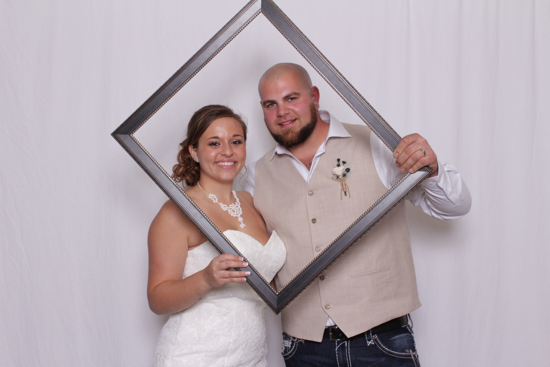 Guests with props in photo booth at a wedding