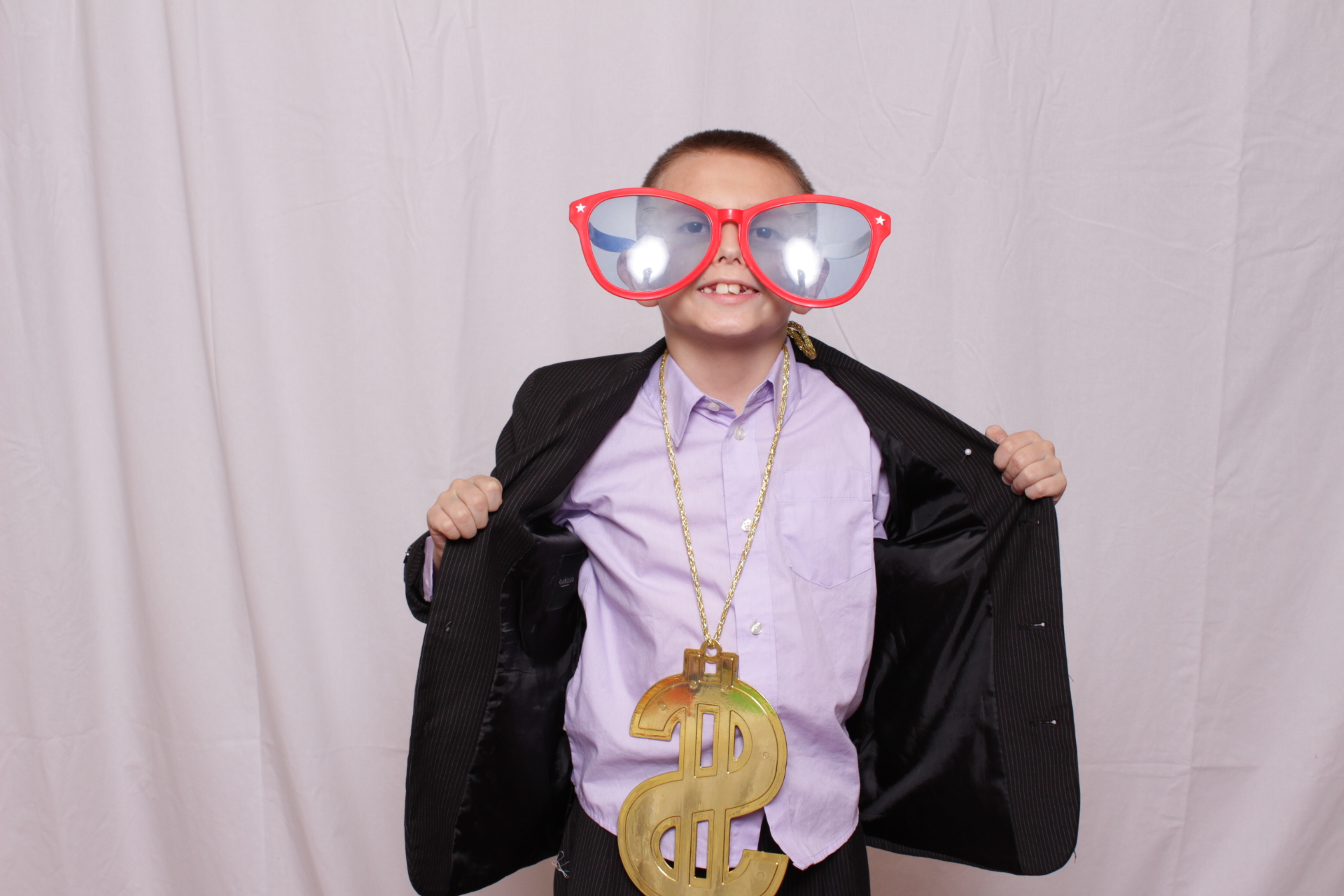 Kids holding money prop in photo booth