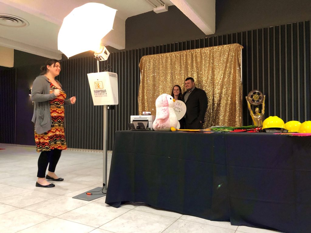 Wide angle shot of photo booth with gold glitter backdrop