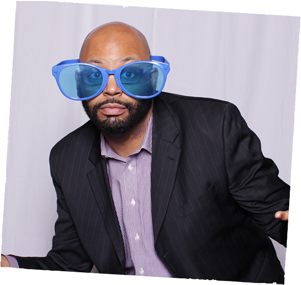 Party guest with blue glasses in photo booth