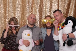 Group of people in photo booth in sylvania ohio with a gold sequin backdrop