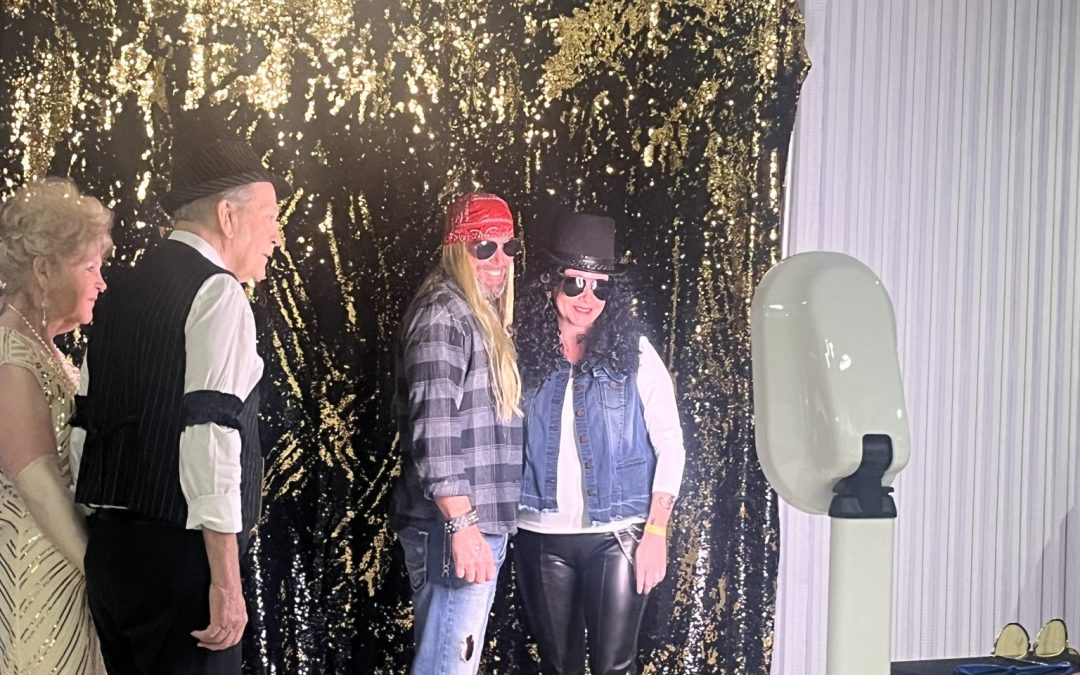 people posing in a photobooth at a corporate event